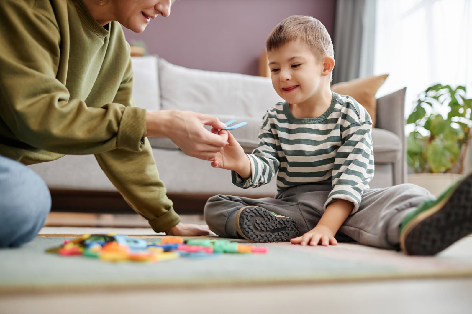 Therapist on the floor with a child doing activities